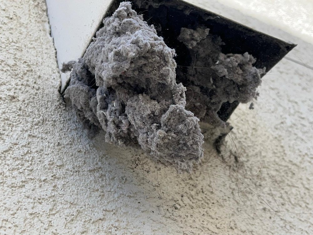 Heavy dryer lint overflow removed during vent cleaning in Oakland, CA