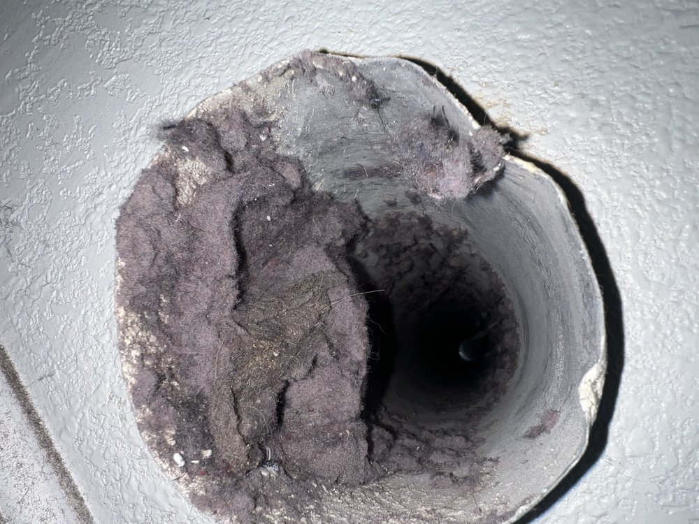 Flexible dryer vent tube with heavy lint buildup in Oakland, CA